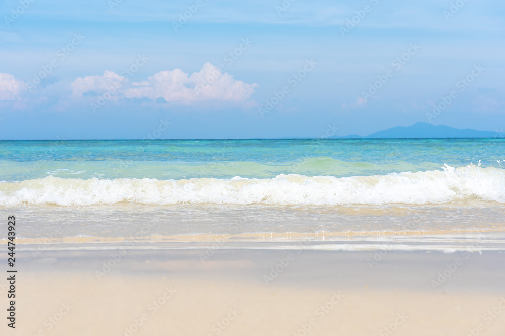 Soft wave of ocean on sand beach with blue ocean sea and sky background in summer vacation.Relaxing time on paradise.Travel,Holliday,Day off Concept. Copy space empty blank for text.