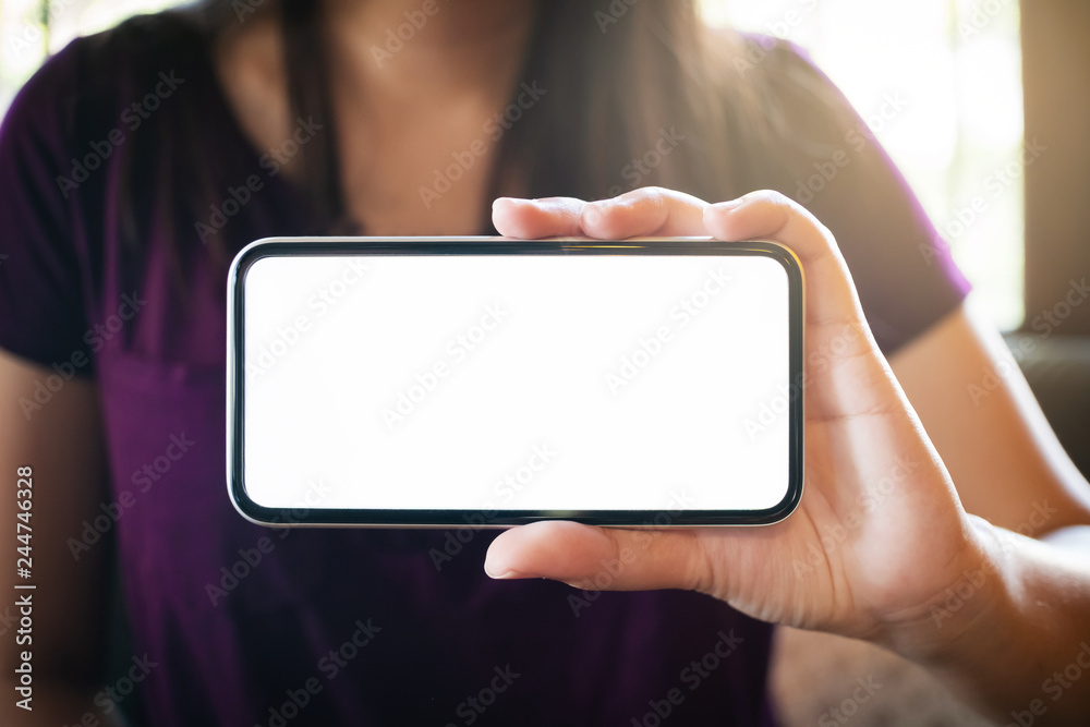 hands of woman holding empty white screen mobile phone