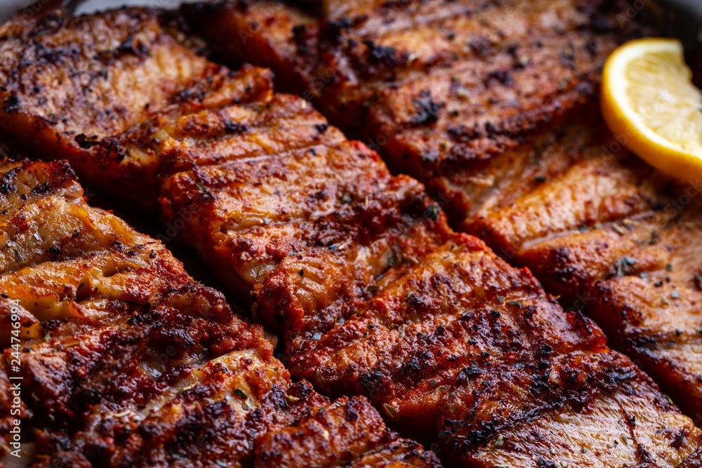Fresh fish grilled texture. Grilled salmon with a slice of juicy lemon Fresh fish grilled texture. Grilled salmon with a slice of juicy lemon
