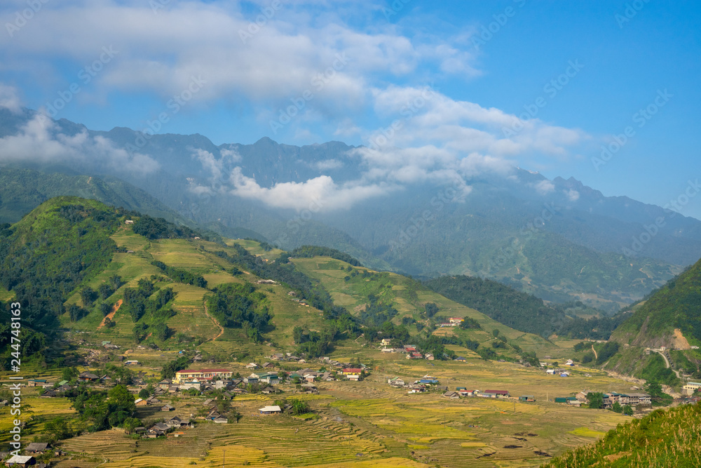 Beautiful Panorama Top view of growing golden paddy rice field in Tavan local village with fansipan mountain and cloudy sky in background, Sapa, Laocai , Northwest of Vietnam
