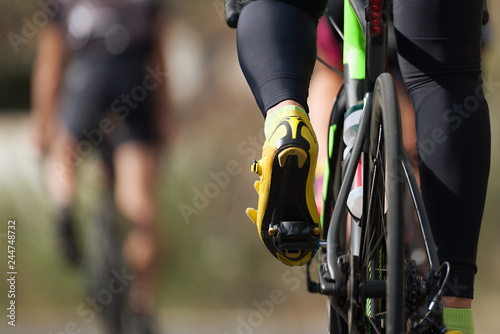 Cycling competition cyclist athletes riding a race at high speed, detail of cycling shoes