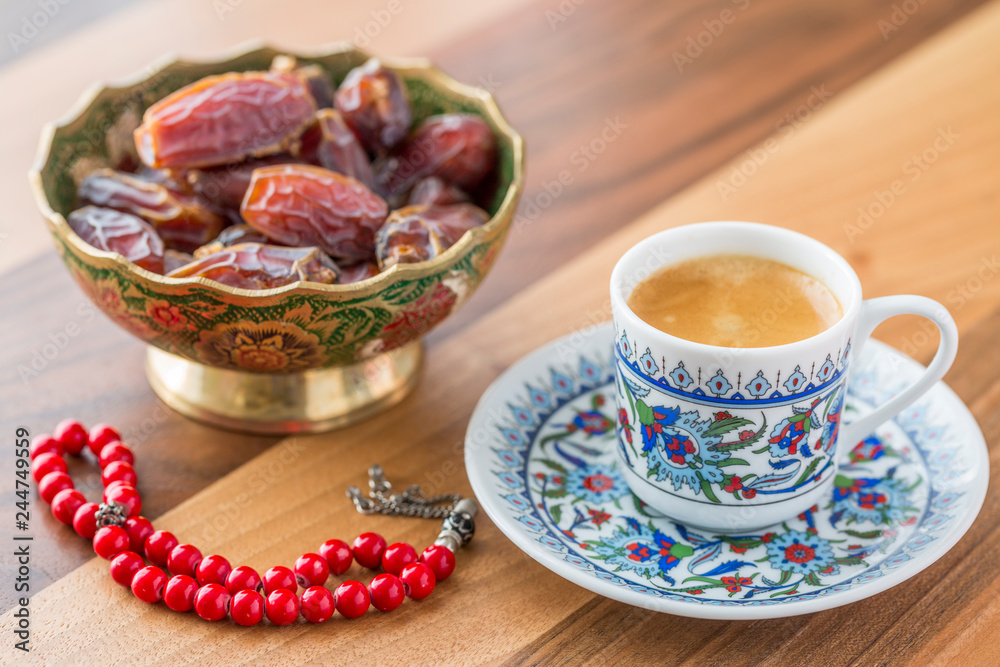 Fototapeta premium Turkish coffee, dates, and red rosary on table side view