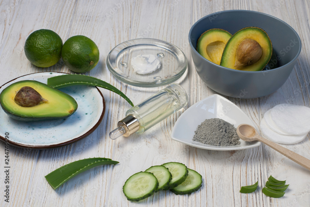 Ingredients for homemade beauty face mask of clay with avocado, cucumber, oil, aloe vera. DIY cosmetics and spa. Top view Ingredients for homemade beauty face mask of clay with avocado, cucumber, oil, aloe vera. DIY cosmetics and spa. Top view