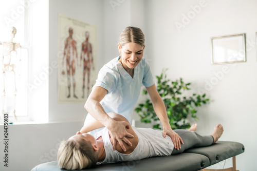 A Modern rehabilitation physiotherapy worker with woman client