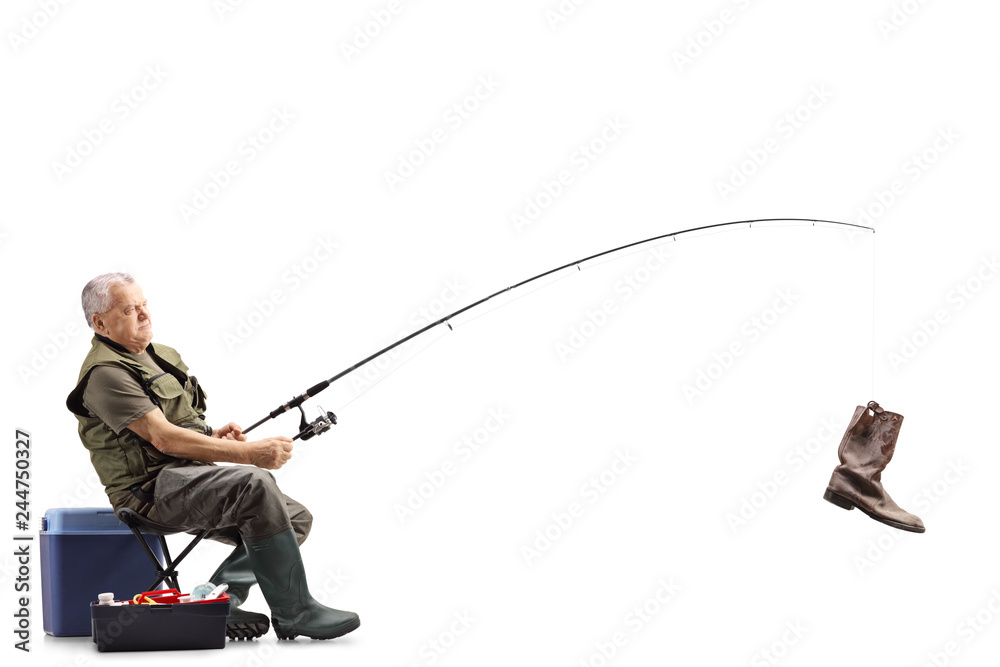 Obraz premium Fisherman on a chair with an old boot on the fishing rod