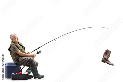 Fisherman on a chair with an old boot on the fishing rod