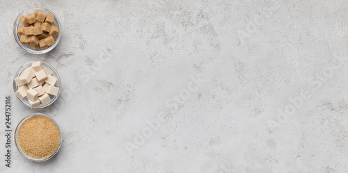 Collection of different kinds of sugar on gray background