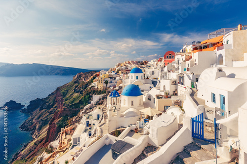 Architecture of Oia village, Santorini island in Greece, on a sunny day with dramatic sky. Scenic travel background.
