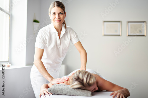 A Woman enjoying spa treatment at salon with masseur worker photo