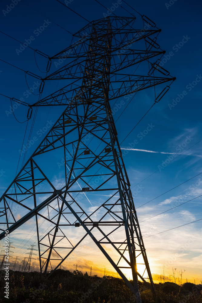 Electricity pylon seen from below at sunset