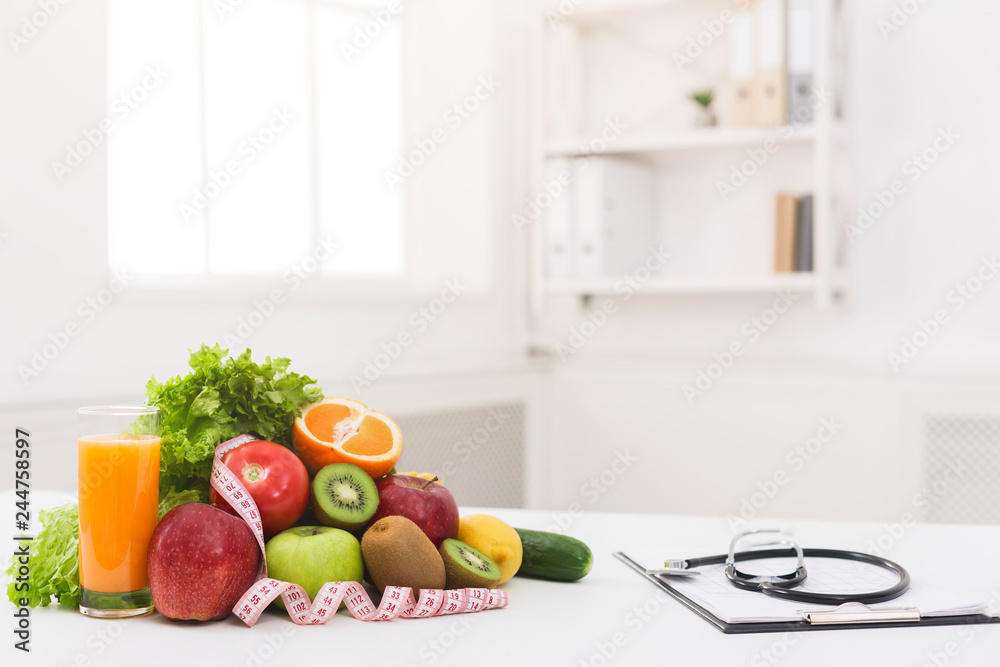 Nutritionist desk with healthy fruit and stethoscope Nutritionist desk with healthy fruit and stethoscope