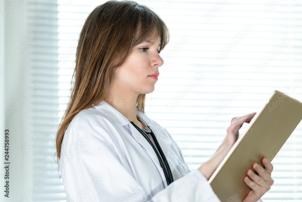 Female doctor using tablet computer Female doctor using tablet computer