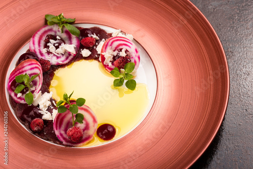 Photography Venison filet slices with forest strawberries, beetroot, almond cream