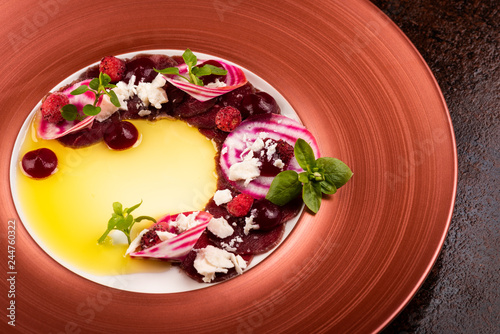 Fototapeta Naklejka Na Ścianę i Meble -  Venison filet slices with forest strawberries, beetroot, almond cream