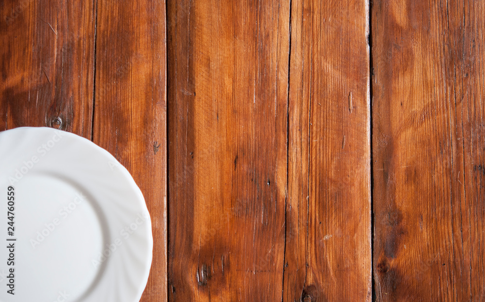 Blank white dish on a wood background. Blank white dish on a wood background.