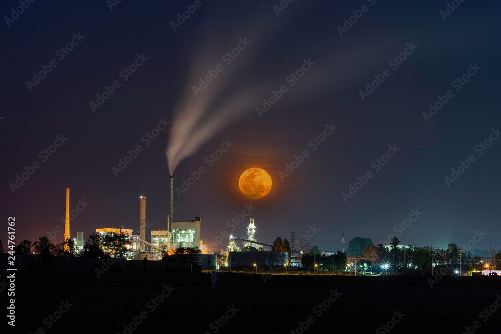 Big moon and Huge power plant with many lights at night