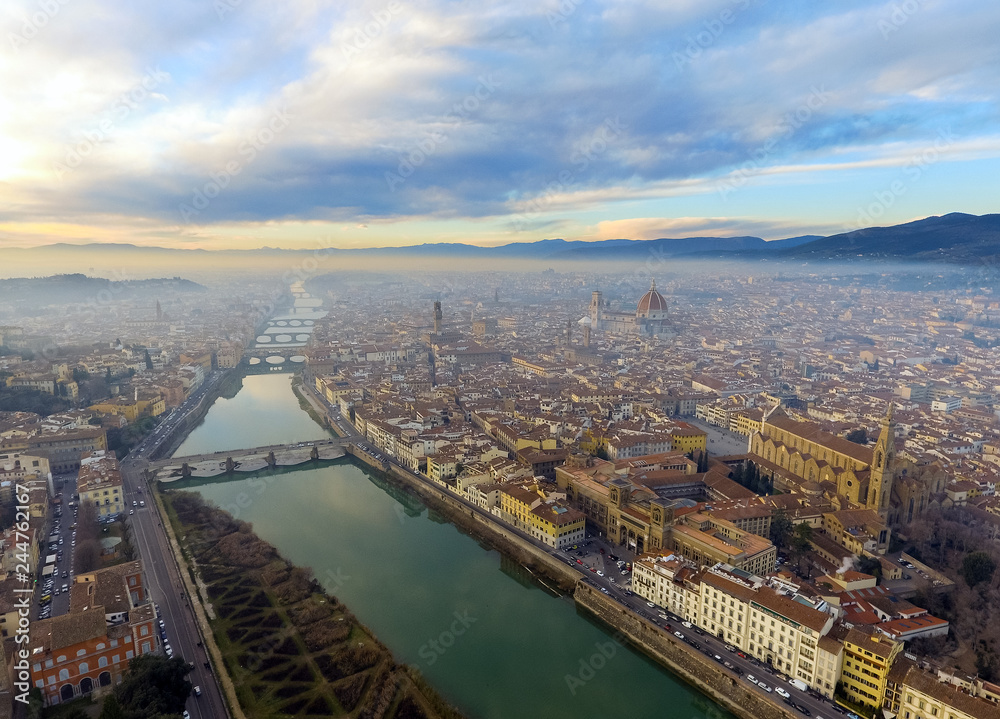 AERIAL. Panorama of the city of FLORENCE in Italy with the dome and Palazzo della Signoria and arno river