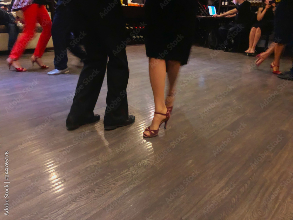 Tango dancing couple, legs in motion, snapshot in close