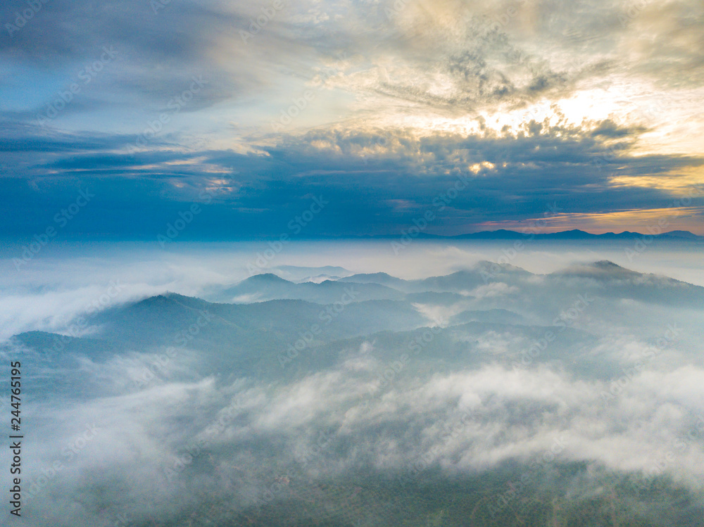 Aerial view of mountain and morning mist during sunrise. Aerial view of mountain and morning mist during sunrise.