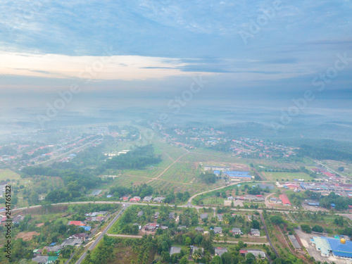 Aerial view of mountain and morning mist during sunrise. © mawardibahar