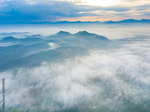 Aerial view of mountain and morning mist during sunrise. © mawardibahar