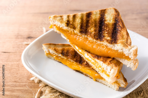 Grilled cheese sandwich on wooden table. Close up