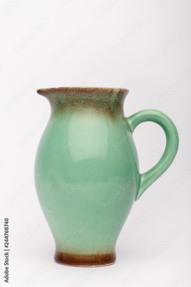 Old green milk jug  on the white background
