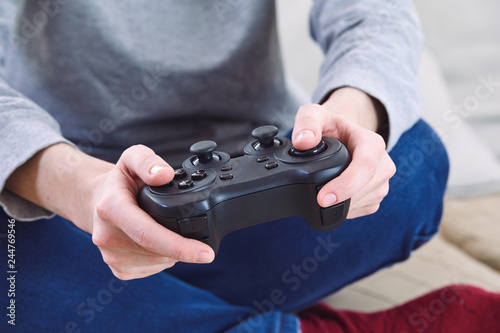 man holding a joystick controllers while playing a video games at home © fox17