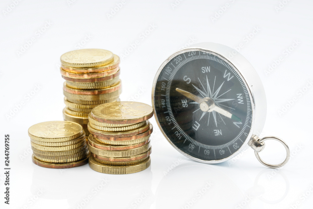 Coins and compass with white background. Financial concept.