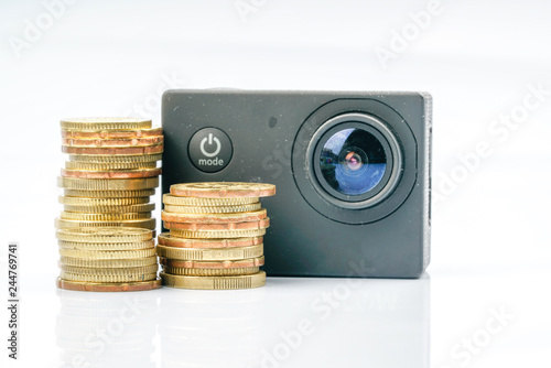 Action camera and coins with financial conceptual. photo