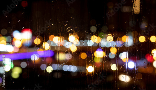 Rain drops on window with road light bokeh
