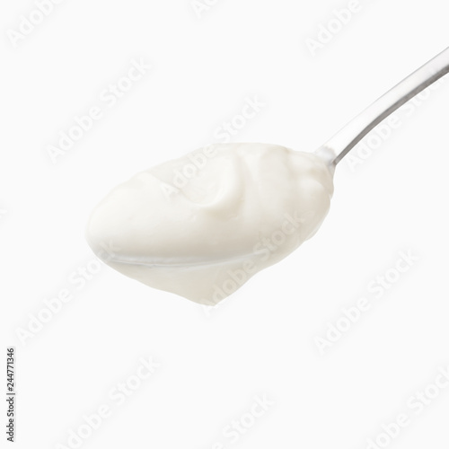 Sour cream in spoon isolated