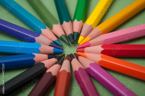 closeup od colorful pencil on green paper background