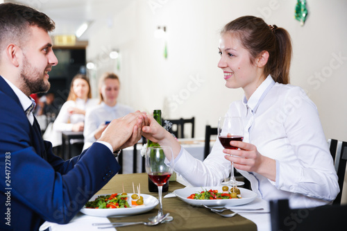 Gentleman with elegant woman are having dinner in luxury restaurante