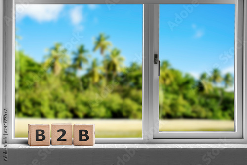 B2B sign in a window on a tropcal island with palm trees photo