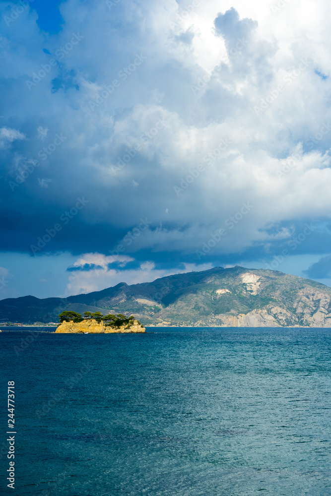 Greece, Zakynthos, Impressive mountains behind cameo island decorated by dramatic cloudscape sky