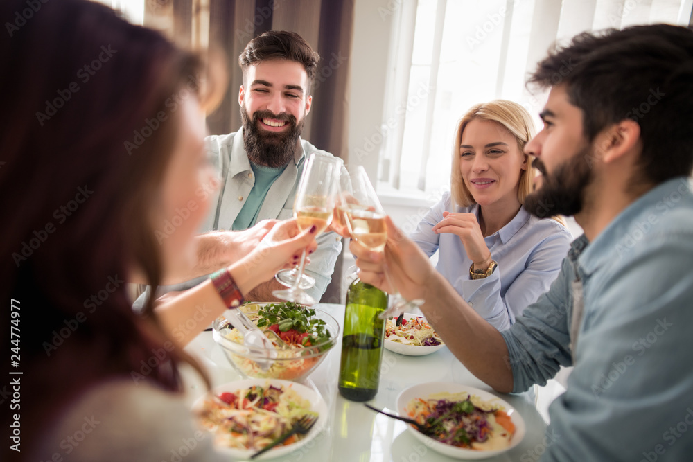 Group of friends enjoying meal at home together Group of friends enjoying meal at home together