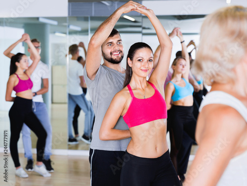 Group of  young adults dancing salsa in club