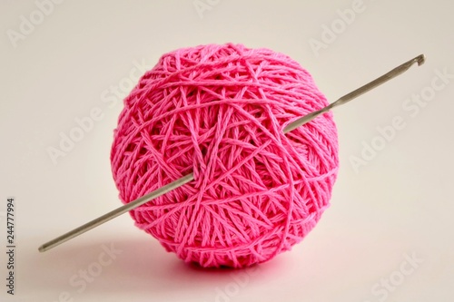 ball of pink yarn and crochet close-up