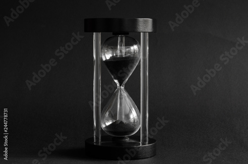 black hourglass on black background