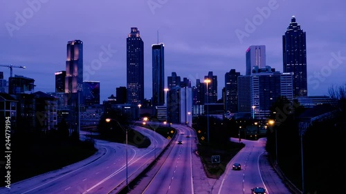 Car traffic moving towards the Atlanta Georgia downtown modern skyline at night. USA