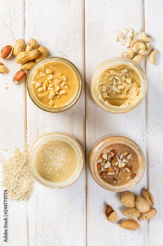 Selection of nut butters - peanut, cashew, almond and sesame seeds, copy space