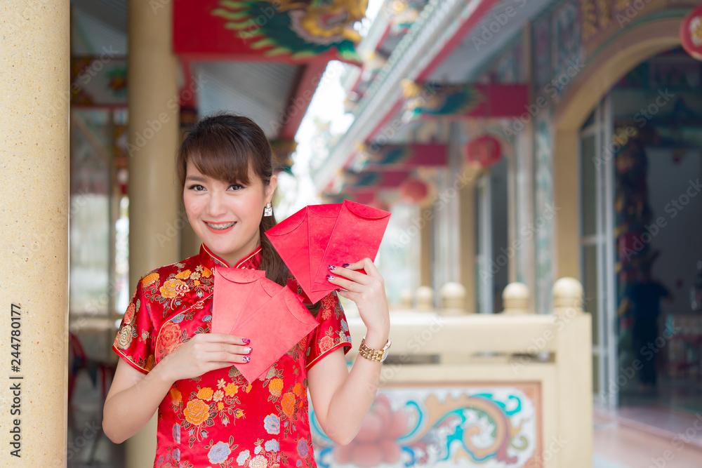 Portrait of beautiful asian woman in Cheongsam dress,Thailand people,Happy Chinese new year concept Portrait of beautiful asian woman in Cheongsam dress,Thailand people,Happy Chinese new year concept