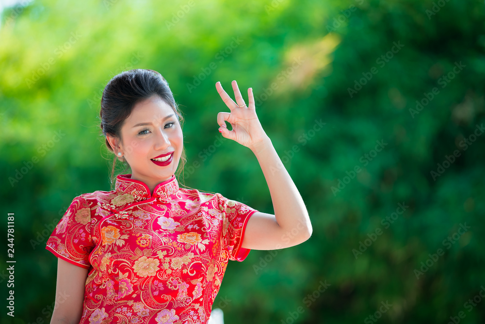 Portrait of beautiful asian woman in Cheongsam dress,Thailand people,Happy Chinese new year concept Portrait of beautiful asian woman in Cheongsam dress,Thailand people,Happy Chinese new year concept