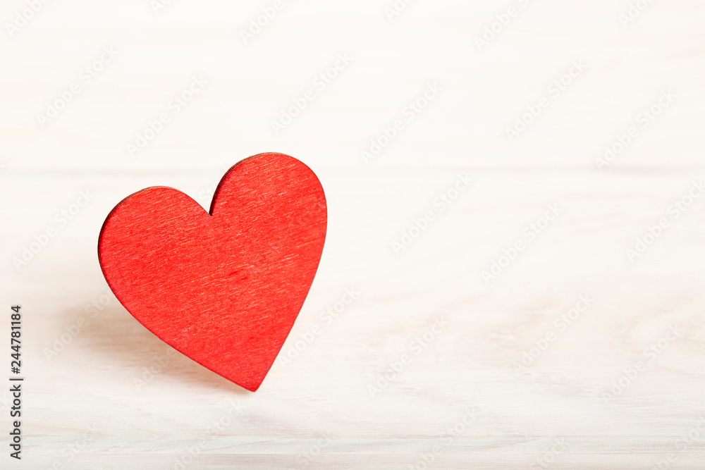 Fototapeta premium Valentine background with red wooden heart at rustic white wood planks. Happy lovers day card mockup, copy space 