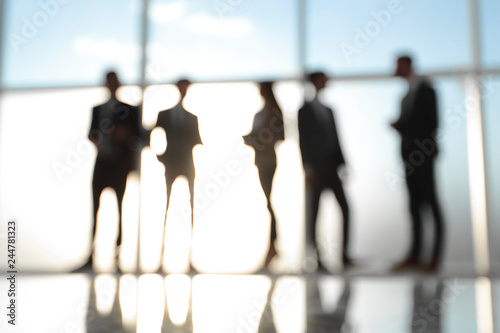 Silhouettes of Business People in Office. Mixed media . photo