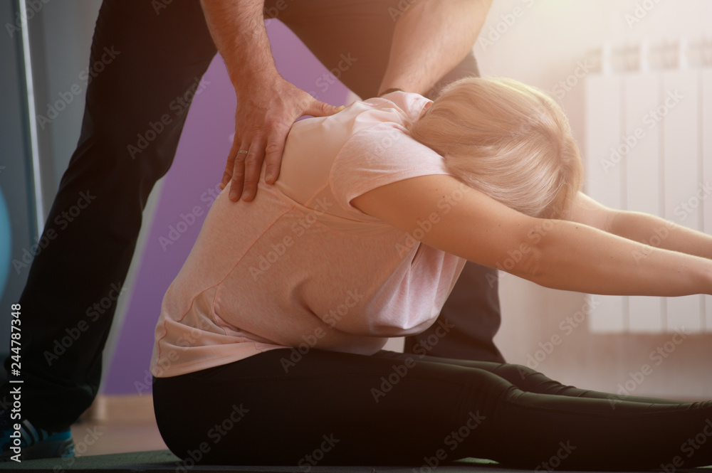 Fototapeta premium Aged woman engaged in stretching ligaments