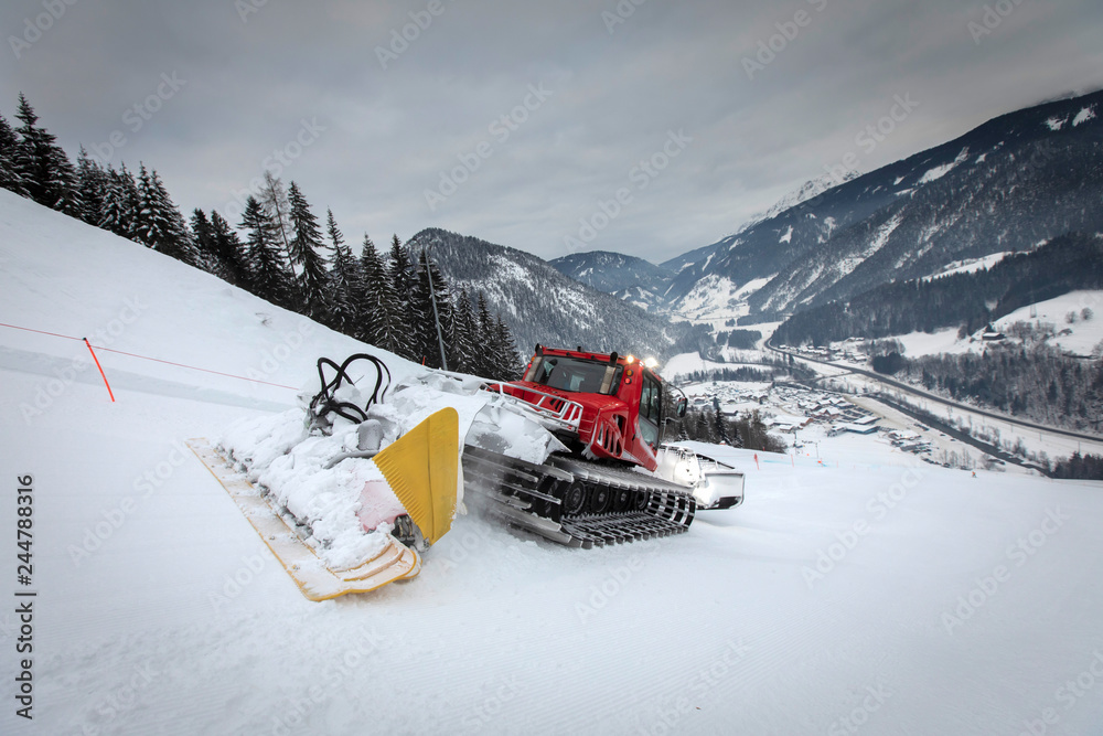 snow groomer on ski slope
