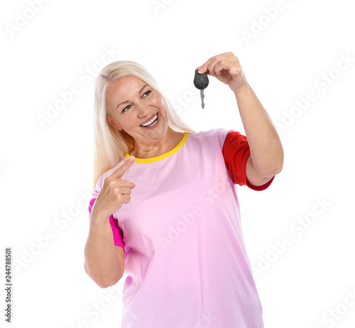 Happy mature woman with car key on white background. Getting driving license