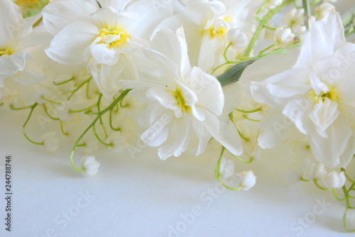 beautiful tender floral composition. Flowers lilies of the valley and daffodils on a white background. spring freshness